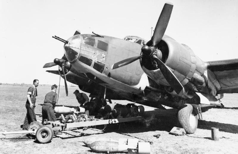 Armourers load 250-lb GP bombs into a Lockheed Ventura Mark II of No. 464 Squadron RAAF at Methwold, Norfolk, using a bomb-trolley borrowed from No. 487 Squadron RNZAF.
