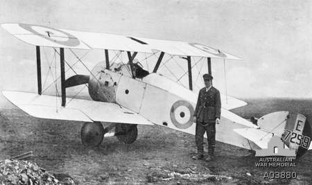 Captain G F Malley of No 4 Squadron, Australian Flying Corp (AFC) at No 5 (Training) Squadron, AFC standing next to an all white Sopwith Camel 1.F.1  E7259 AWM A03880 via Brendan Cowan